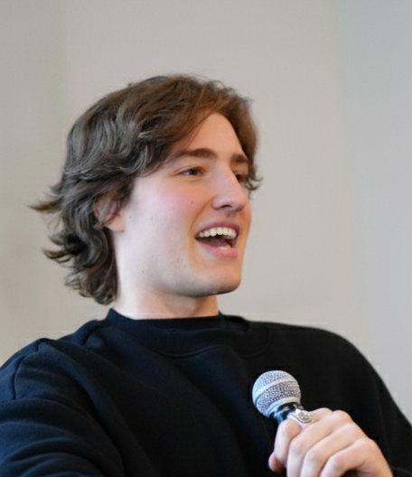 Clark speaking into a microphone
